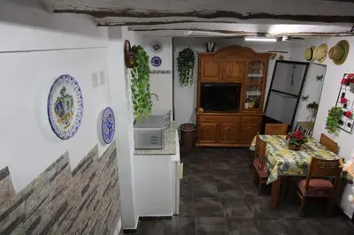 a kitchen and dining room with a table and a refrigerator at Casa de pueblo en Calles in Calles