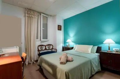 a hotel room with a bed with a blue wall at Mirador 1 del Mercado Central - habitacion con baño privado en el centro de la Ciudad Vella in Valencia
