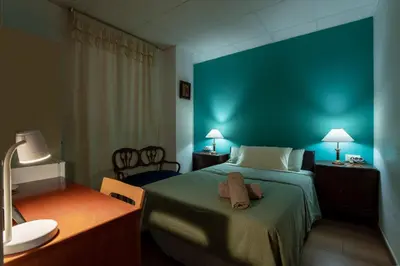 a bedroom with a bed and a blue wall at Mirador 1 del Mercado Central - habitacion con baño privado en el centro de la Ciudad Vella in Valencia