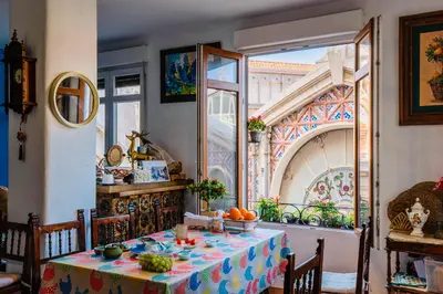 a dining room with a table and a window at Mirador 1 del Mercado Central - habitacion con baño privado en el centro de la Ciudad Vella in Valencia