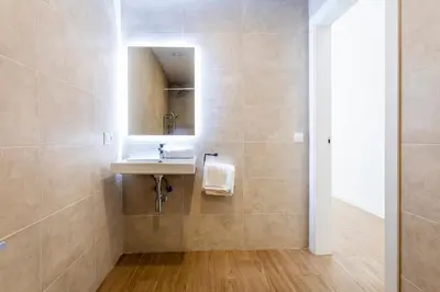 a bathroom with a sink and a mirror at SOROLLA APARTMENTS CENTRAL Station in Valencia