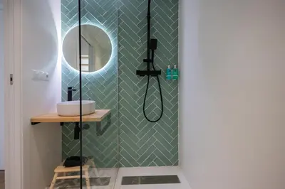 a bathroom with a shower with a mirror at FLORIT FLATS - The Mediterranean Suites in Valencia