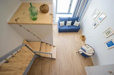 an overhead view of a living room with a blue couch at FLORIT FLATS - The Mediterranean Suites in Valencia