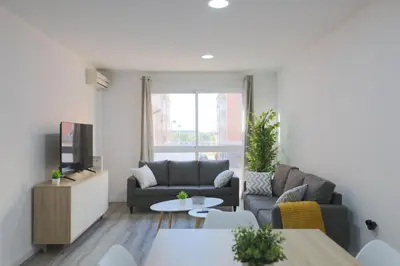 a living room with a couch and a tv at Esplendido apartamento para 6 personas by Hometels in Puerto de Sagunto