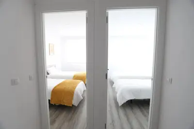 two mirrors in a room with two beds at Esplendido apartamento para 6 personas by Hometels in Puerto de Sagunto