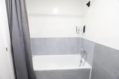 a white bath tub in a bathroom with a shower at Esplendido apartamento para 6 personas by Hometels in Puerto de Sagunto