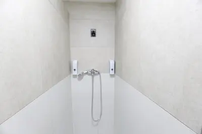 a bathroom with a shower in a white room at Esplendido apartamento para 6 personas by Hometels in Puerto de Sagunto