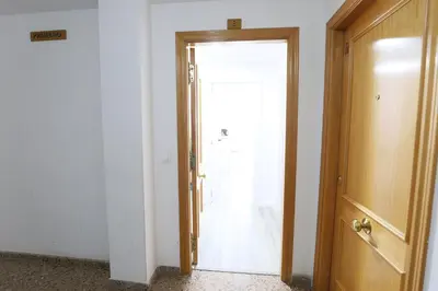 an open door to a room with a white door at Esplendido apartamento para 6 personas by Hometels in Puerto de Sagunto