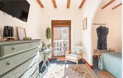 a bedroom with a bed and a dresser with a tv at Ensueño Alojamiento Turístico in Alcublas