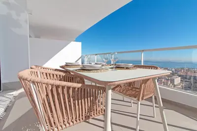a table and chairs on a balcony with a view at Global Vacacional, Moderno apartamento de dos terrazas con increíbles vistas al mar in Canet de Berenguer