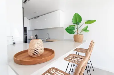 a kitchen with a wooden table and two chairs at Global Vacacional, Moderno apartamento de dos terrazas con increíbles vistas al mar in Canet de Berenguer