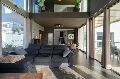 a living room with a large blue couch in a house at Descubre Villa Oasis - Confort, diseño y naturaleza a un paso de Valencia in Chiva