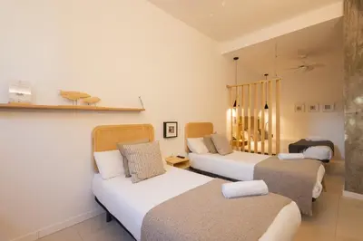 a room with two beds and a couch at FLORIT FLATS - The Pitiusas Rooms in Valencia