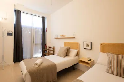 a bedroom with a bed and a window at FLORIT FLATS - The Pitiusas Rooms in Valencia