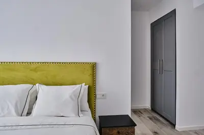 a bedroom with a bed with a green headboard at Arenas flat in Valencia