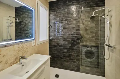 a bathroom with a sink and a glass shower at Arenas flat in Valencia
