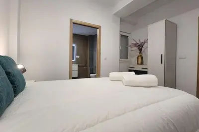 a large white bed in a white room at Casa Valencia al mar in Valencia