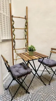 a table and two chairs with a potted plant on it at Casa Valencia al mar in Valencia