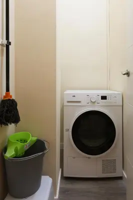 a microwave oven sitting next to a trash can at Non Stress Nuevo Turia in Valencia