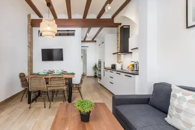 a living room with a table and a couch at Cabanyal Sunny Beach House in Valencia