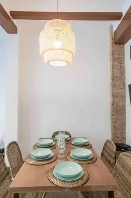 a dining room table with blue and white plates on it at Cabanyal Sunny Beach House in Valencia