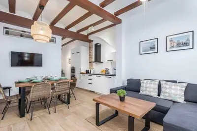 a living room with a couch and a table at Cabanyal Sunny Beach House in Valencia
