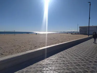 a person walking on a beach with a fountain at Habitación en la playa in Valencia