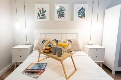 a bedroom with a tray of food on a bed at Nice lodging near the Plaza de Toros in Valencia