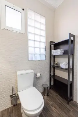 a bathroom with a white toilet and a window at Nice lodging near the Plaza de Toros in Valencia