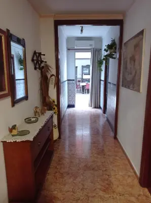 a hallway leading to a living room with a table and a hallwayngth at CA ÁNGEL in Anna