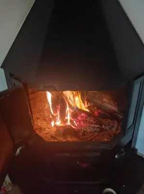 a fire in a brick oven with flames in it at CA ÁNGEL in Anna