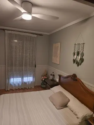 a bedroom with a bed and a ceiling fan at CA ÁNGEL in Anna