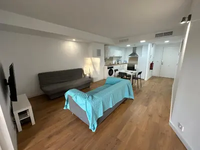 a living room with a couch and a table at Apartamentos Canet al Mar. in Canet de Berenguer