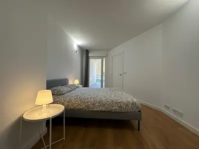 a bedroom with a bed and a table with a lamp at Apartamentos Canet al Mar. in Canet de Berenguer