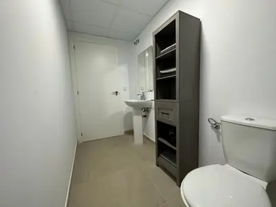 a bathroom with a toilet and a sink at Apartamentos Canet al Mar. in Canet de Berenguer