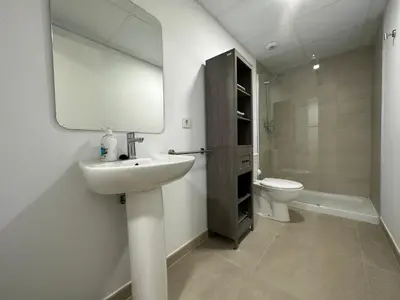 a bathroom with a sink and a toilet and a mirror at Apartamentos Canet al Mar. in Canet de Berenguer