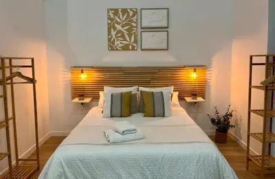 a bedroom with a large bed with two towels on it at Loft cerca de playa y Ciudad de Artes y Ciencias in Valencia