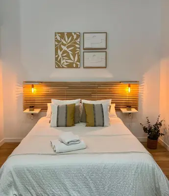 a bedroom with a large bed with two towels on it at Loft cerca de playa y Ciudad de Artes y Ciencias in Valencia