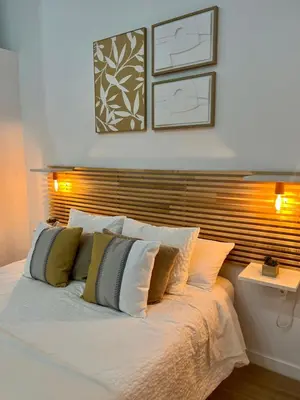 a bedroom with a white bed with four pillows at Loft cerca de playa y Ciudad de Artes y Ciencias in Valencia