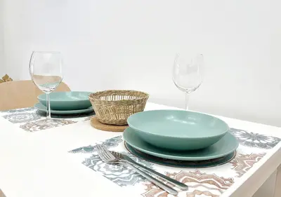 a table with two plates and wine glasses on it at Loft cerca de playa y Ciudad de Artes y Ciencias in Valencia
