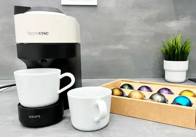 a coffee maker next to cups and a box of easter eggs at Loft cerca de playa y Ciudad de Artes y Ciencias in Valencia