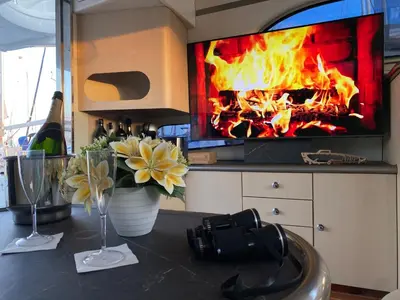 a table with flowers and wine glasses and a fireplace at The Valencia Yacht Experience in Valencia