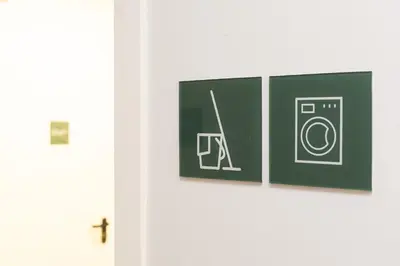 a door with three pictures of a washing machine at Moontels Plaza de Vannes in Valencia