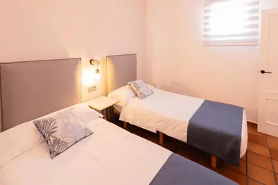 a room with two beds and a window at Cozy Up Spain in Valencia