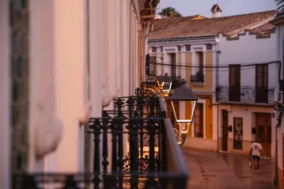 a city street with a black fence and buildings at Cozy Up Spain in Valencia