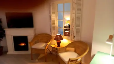 a living room with two chairs and a table with a lamp at El rinconet in Partida de La Cañada
