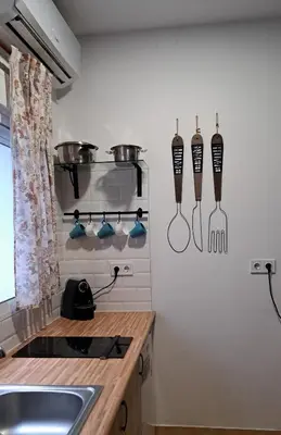 a kitchen with a sink and utensils on the wall at APARTAMENTO MARÍTIMO in Valencia