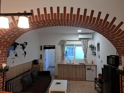 a kitchen and a living room with a brick wall at APARTAMENTO MARÍTIMO in Valencia