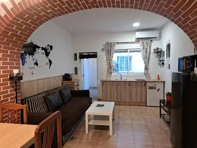 a living room with a couch and a kitchen at APARTAMENTO MARÍTIMO in Valencia