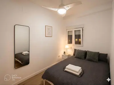 a hallway with white walls and a wooden door at Dulces Sueños Amistad in Valencia